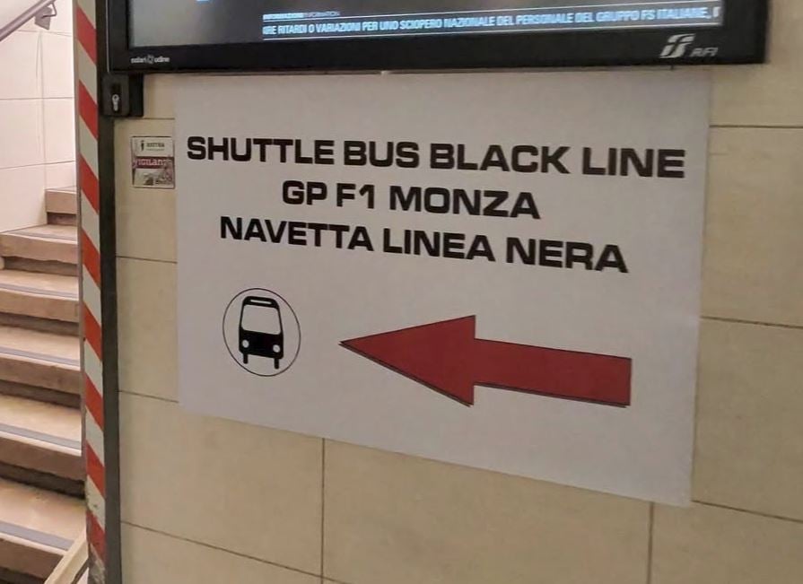 Black shuttle bus sign at Monza train station for the F1